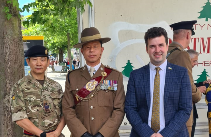 Elliot with members of the Armed Forces at the Armed Forces Day flag raising service.